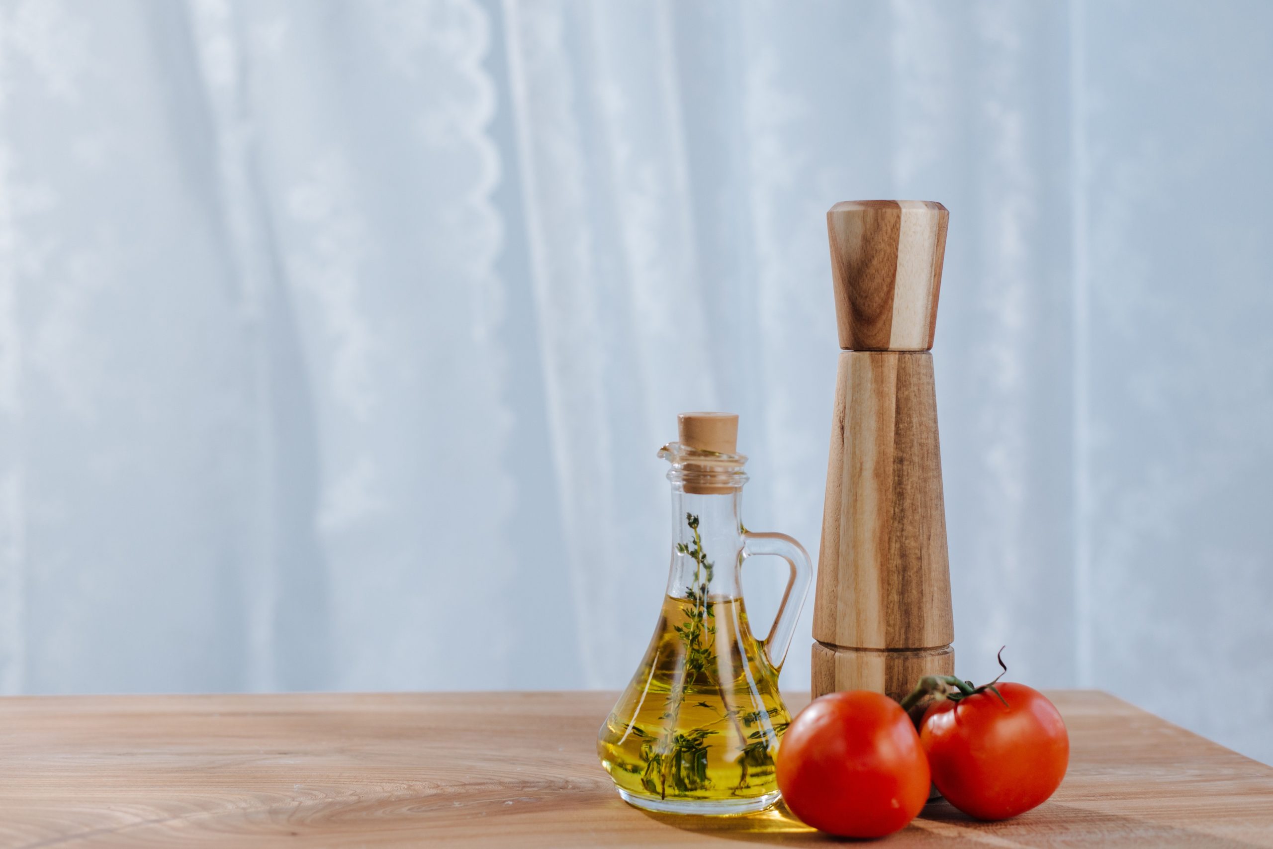pexels-ron-lach-10054918 Bottle of olive oil next to a pepper shaker and two tomatoes on a vine. Olive oil is full of unsaturated fats which support brain health and function. Image from Pexels.